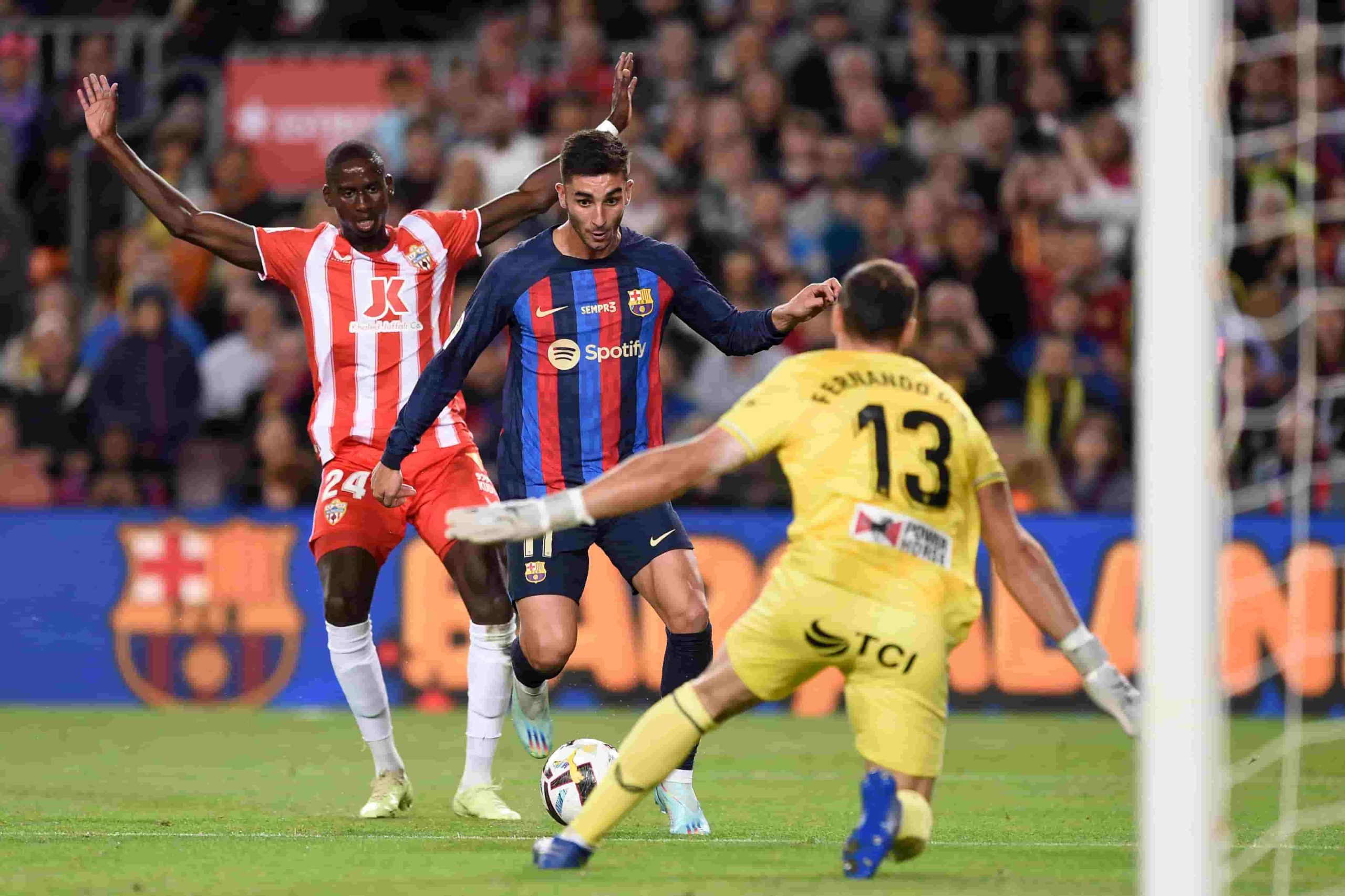 Barcelona's Spanish forward Ferran Torres (C) vies with Almeria's Guinean defender Houboulang Mendes (L) during the Spanish league football match between FC Barcelona and UD Almeria at the Camp Nou stadium in Barcelona on November 5, 2022. (Photo by Josep LAGO / AFP) (Photo by JOSEP LAGO/AFP via Getty Images)