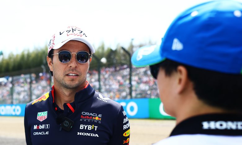SUZUKA, JAPAN - APRIL 07: Sergio Perez of Mexico and Oracle Red Bull Racing talks with Yuki Tsunoda of Japan and Visa Cash App RB on the drivers parade prior to the F1 Grand Prix of Japan at Suzuka International Racing Course on April 07, 2024 in Suzuka, Japan. (Photo by Mark Thompson/Getty Images)