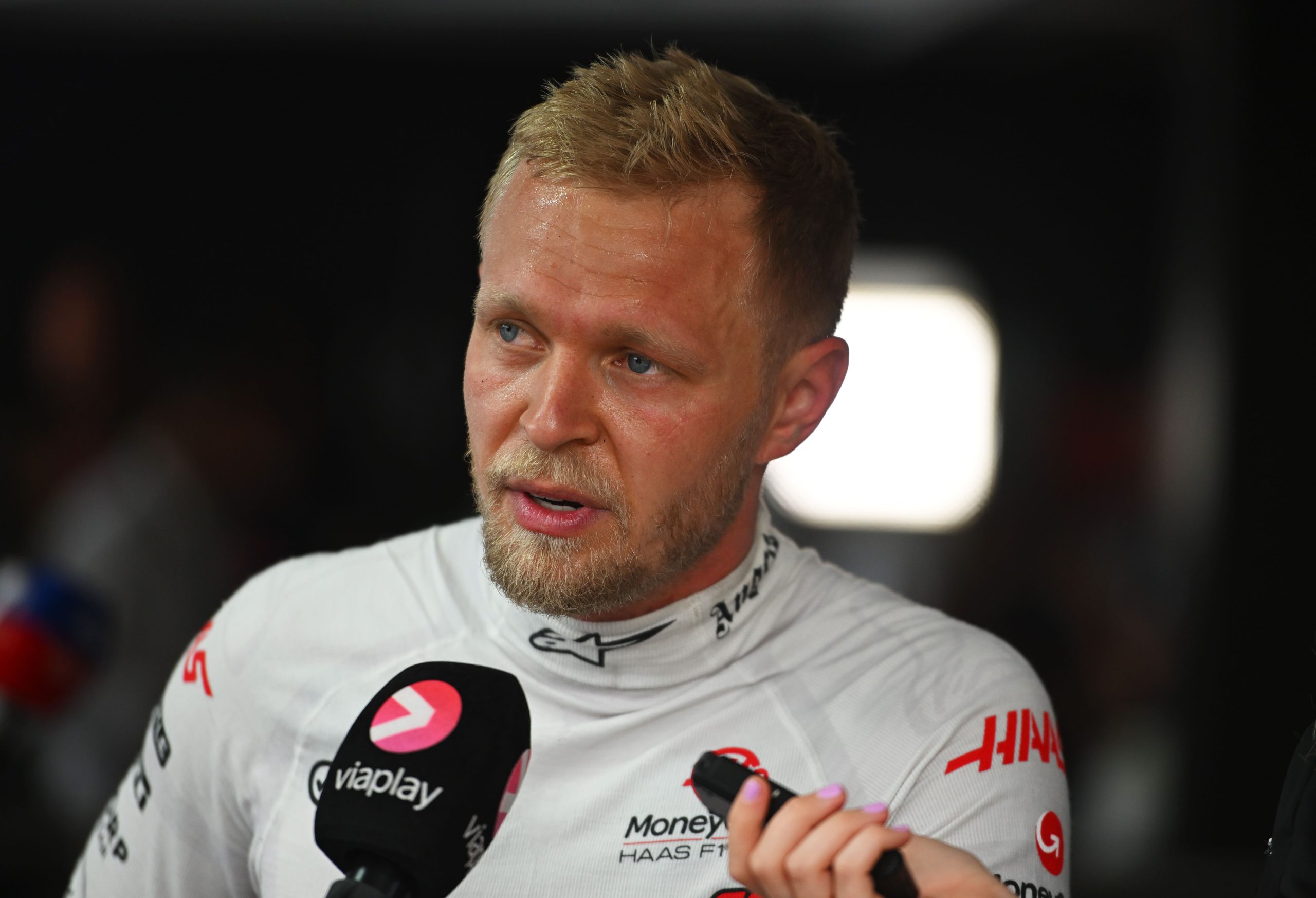 SPIELBERG, AUSTRIA - JUNE 30: 8th placed Kevin Magnussen of Denmark and Haas F1 talks to the media in the Paddock after the F1 Grand Prix of Austria at Red Bull Ring on June 30, 2024 in Spielberg, Austria. (Photo by Rudy Carezzevoli/Getty Images)