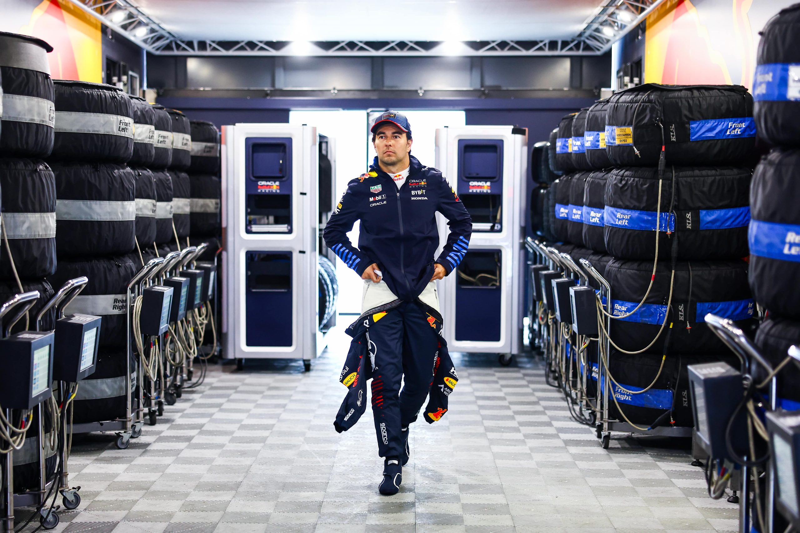 NORTHAMPTON, ENGLAND - JULY 06: Sergio Perez of Mexico and Oracle Red Bull Racing walks into the garage prior to final practice ahead of the F1 Grand Prix of Great Britain at Silverstone Circuit on July 06, 2024 in Northampton, England. (Photo by Mark Thompson/Getty Images)