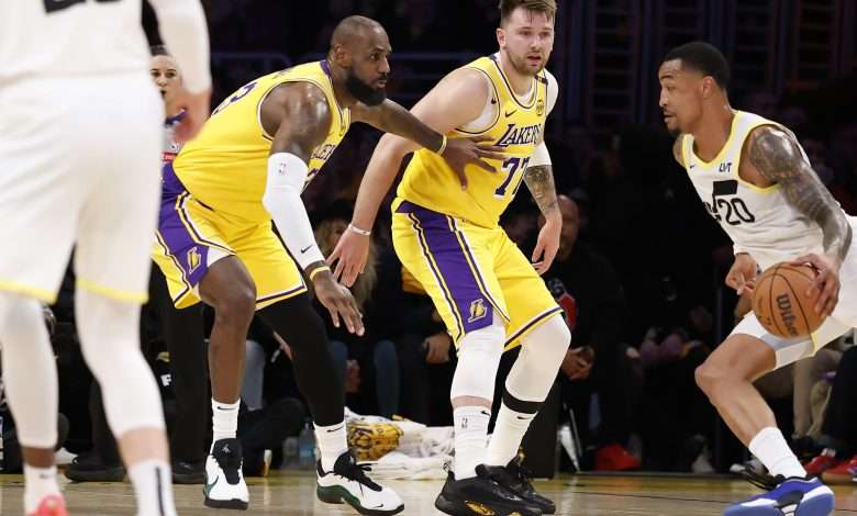 LOS ANGELES, CALIFORNIA - FEBRUARY 10: LeBron James #23 and Luka Doncic #77 of the Los Angeles Lakers look on as John Collins #20 of the Utah Jazz drives to the basket during the first quarter at Crypto.com Arena on February 10, 2025 in Los Angeles, California. (Photo by Ronald Martinez/Getty Images)