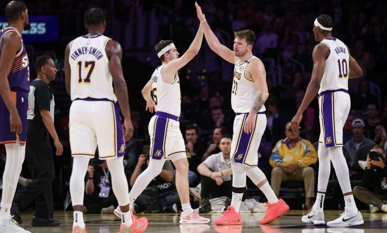 LOS ANGELES, CALIFORNIA - MARCH 16: Luka Doncic #77 of the Los Angeles Lakers high-fives Austin Reaves #15 in the second half against the Phoenix Suns at Crypto.com Arena on March 16, 2025 in Los Angeles, California. NOTE TO USER: User expressly acknowledges and agrees that, by downloading and or using this Photograph, user is consenting to the terms and conditions of the Getty Images License Agreement. (Photo by Meg Oliphant/Getty Images)