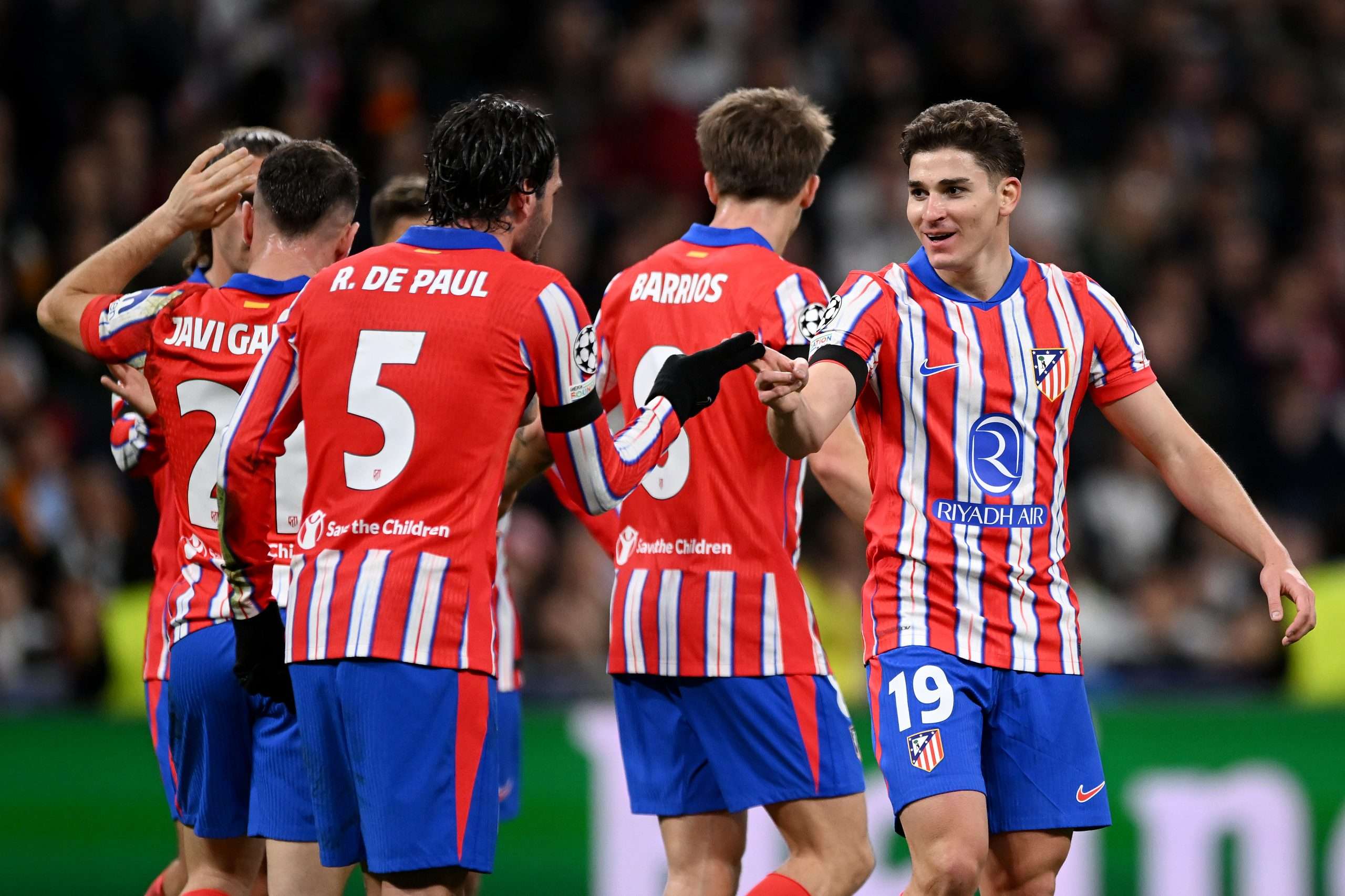 MADRID, SPAIN - MARCH 04: Julian Alvarez of Atletico de Madrid celebrates scoring his team's first goal with teammate Rodrigo De Paul during the UEFA Champions League 2024/25 Round of 16 first leg match between Real Madrid C.F. and Atletico de Madrid at Santiago Bernabeu Stadium on March 04, 2025 in Madrid, Spain. (Photo by Denis Doyle/Getty Images)
