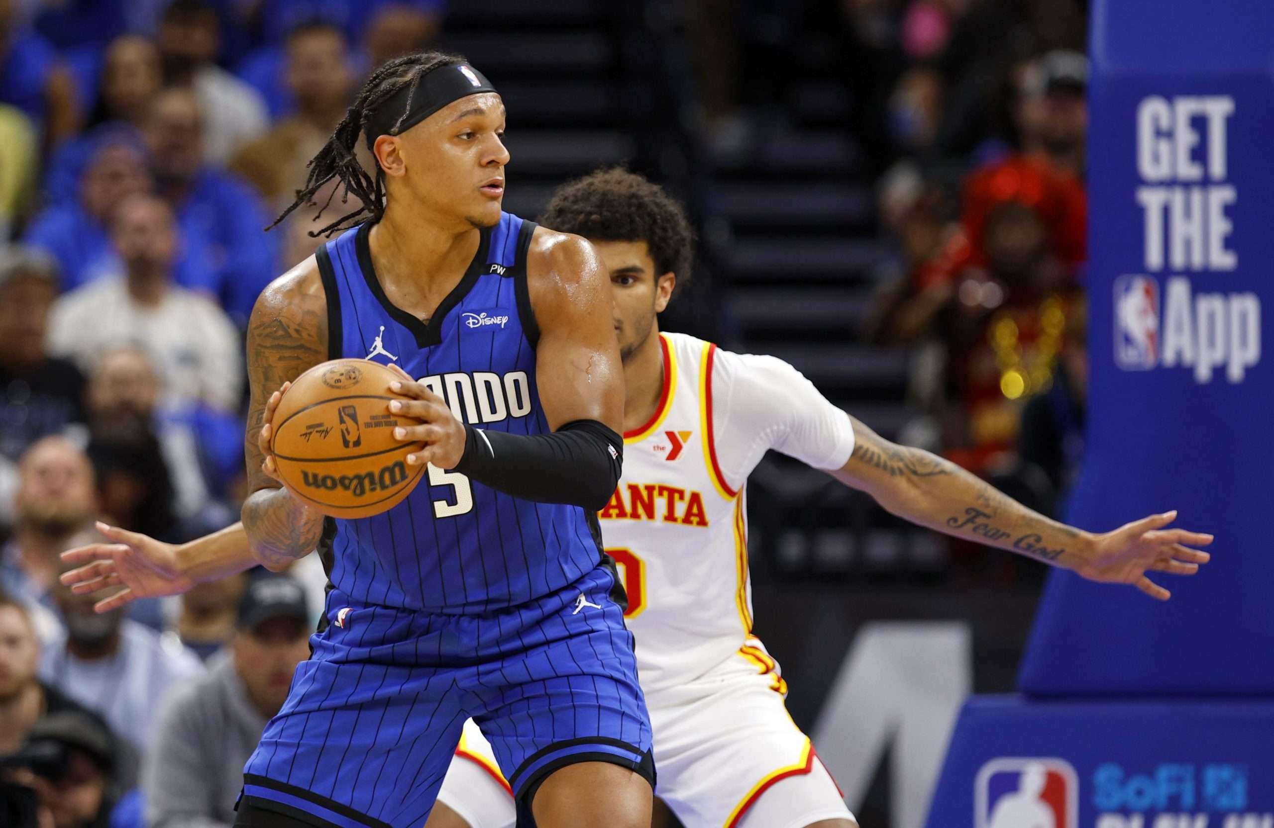 ORLANDO, FLORIDA - APRIL 15: Paolo Banchero #5 of the Orlando Magic posts up Zaccharie Risacher #10 of the Atlanta Hawks during the first half of an NBA play-in tournament game at Kia Center on April 15, 2025 in Orlando, Florida. NOTE TO USER: User expressly acknowledges and agrees that, by downloading and or using this photograph, User is consenting to the terms and conditions of the Getty Images License Agreement. (Photo by Mike Ehrmann/Getty Images)