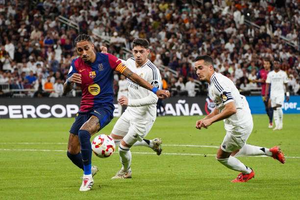 EDDAH, SAUDI ARABIA - 2025/01/12: Barcelona's Brazilian player Rafael Alcantara do Nascimento known as Raphinha (L) seen in action with Real Madrid's Spanish player Lucas Vazquez (R) during the Spanish Super Cup final match El Clasico between FC Barcelona and Real Madrid at King Abdullah Sports City. Final Score : Real Madrid 2 : 5 FC Barcelona. (Photo by Ismael Adnan/SOPA Images/LightRocket via Getty Images)