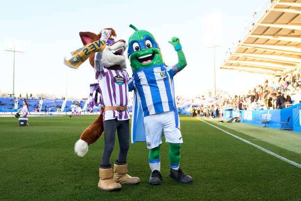 LEGANES, SPAIN - FEBRUARY 03: Super Pepino, mascot of CD Leganes, and Pepe Zorrillo, mascot of Real Valladolid, wave the fans prior to the LaLiga Hypermotion match between CD Leganes and Real Valladolid CF at Estadio Municipal de Butarque on February 03, 2024 in Leganes, Spain. (Photo by Angel Martinez/Getty Images)