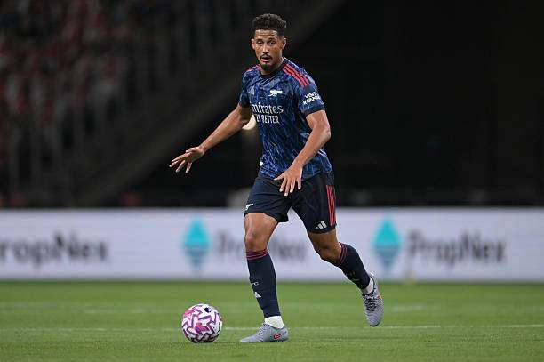 SINGAPORE, SINGAPORE - JULY 27: William Saliba of Arsenal runs with the ball during the Pre-Season Friendly between Arsenal FC and Newcastle United at The Singapore National Stadium on July 27, 2025 in Singapore. (Photo by Stuart MacFarlane/Arsenal FC via Getty Images)