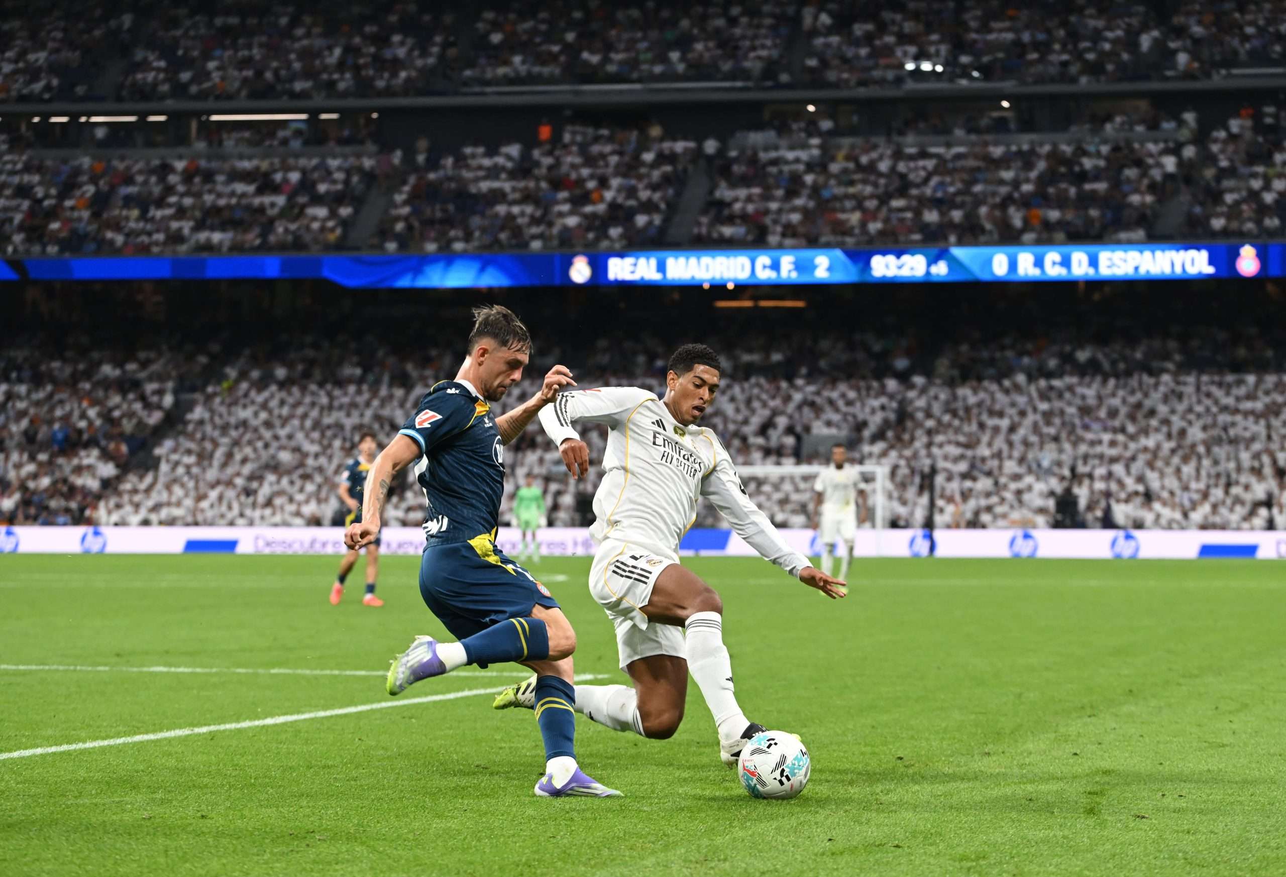 MADRID, SPAIN - SEPTEMBER 20: Jofre Carreras of RCD Espanyol is tackled by Jude Bellingham of Real Madrid during the LaLiga EA Sports match between Real Madrid CF and RCD Espanyol de Barcelona at Estadio Santiago Bernabeu on September 20, 2025 in Madrid, Spain. (Photo by Denis Doyle/Getty Images)