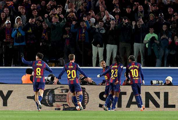 Barcelona's Brazilian forward #11 Raphinha (C) celebrates scoring his team's first goal with teammates during the Spanish league football match between FC Barcelona and Club Atletico de Madrid at Camp Nou Stadium in Barcelona on December 2, 2025. (Photo by Lluis GENE / AFP via Getty Images)