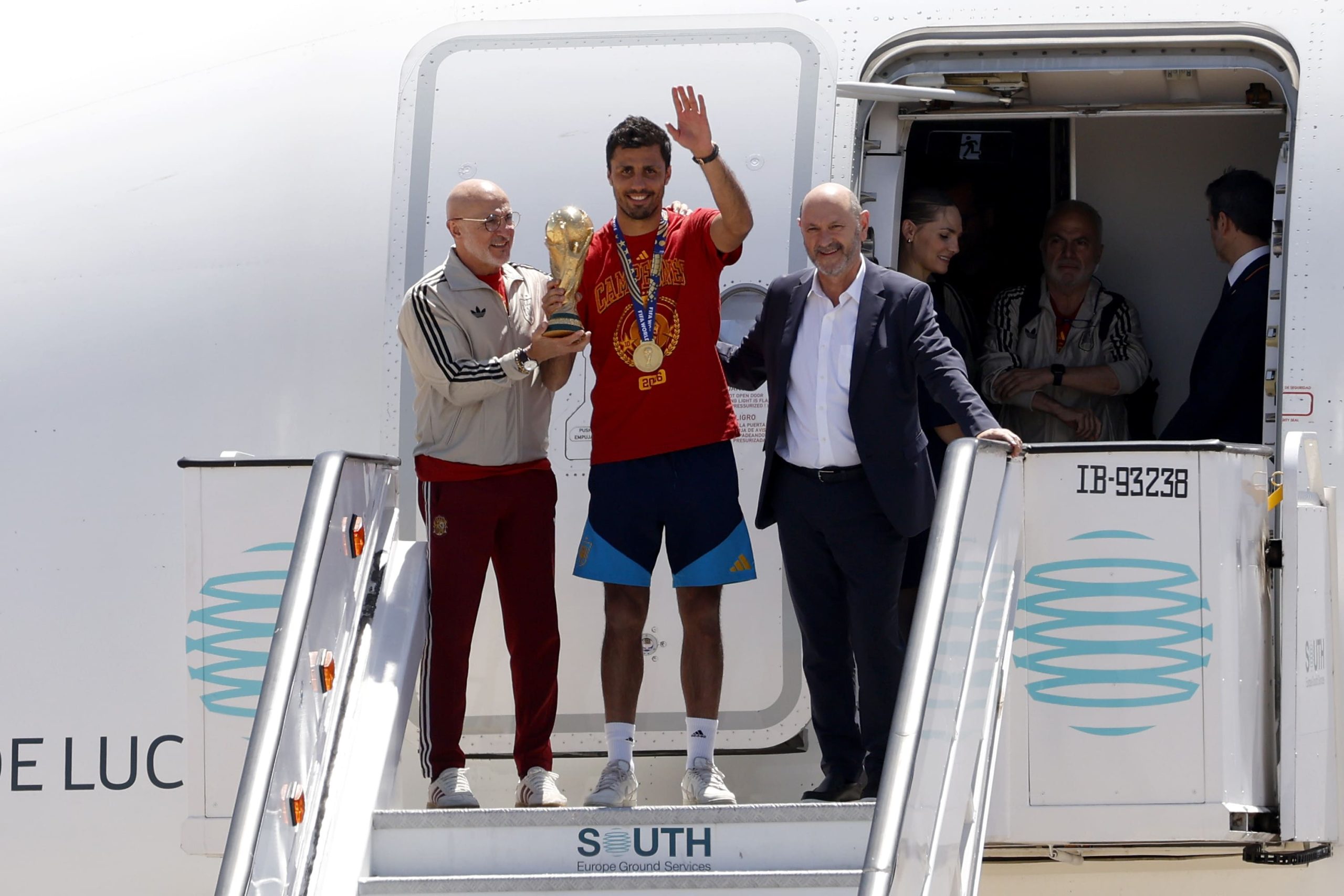 Luis de la Fuente, Head Coach of Spain, Rodri of Spain and Rafael Louzan, Spain Football Association President, pose with the trophy as the Spanish team arrive at Adolfo Suarez Madrid–Barajas Airport ahead of the FIFA World Cup 2026 Trophy parade on July 20, 2026 in Madrid, Spain. The final match of the FIFA World Cup 2026 was held at New York New Jersey Stadium in New Jersey between Spain and Argentina. (Photo by Pablo Blazquez Dominguez/Getty Images)