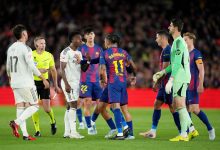 Vinicius Junior of Real Madrid clashes with Raphinha of FC Barcelona, before Referee Alejandro Hernandez Hernandez shows a yellow card to Raphinha, during the LaLiga EA Sports match between FC Barcelona and Real Madrid CF at Spotify Camp Nou on May 10, 2026 in Barcelona, Spain. (Photo by Alex Caparros/Getty Images)