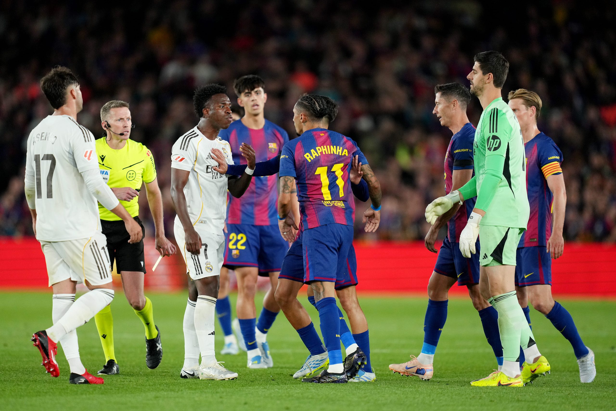 Vinicius Junior of Real Madrid clashes with Raphinha of FC Barcelona, before Referee Alejandro Hernandez Hernandez shows a yellow card to Raphinha, during the LaLiga EA Sports match between FC Barcelona and Real Madrid CF at Spotify Camp Nou on May 10, 2026 in Barcelona, Spain. (Photo by Alex Caparros/Getty Images)